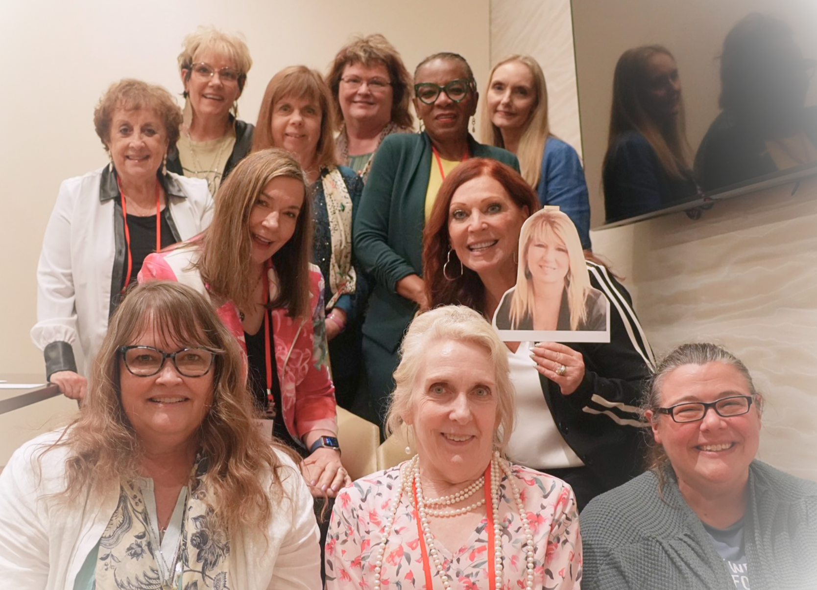 Group of about ten members posed on stairs at the conference