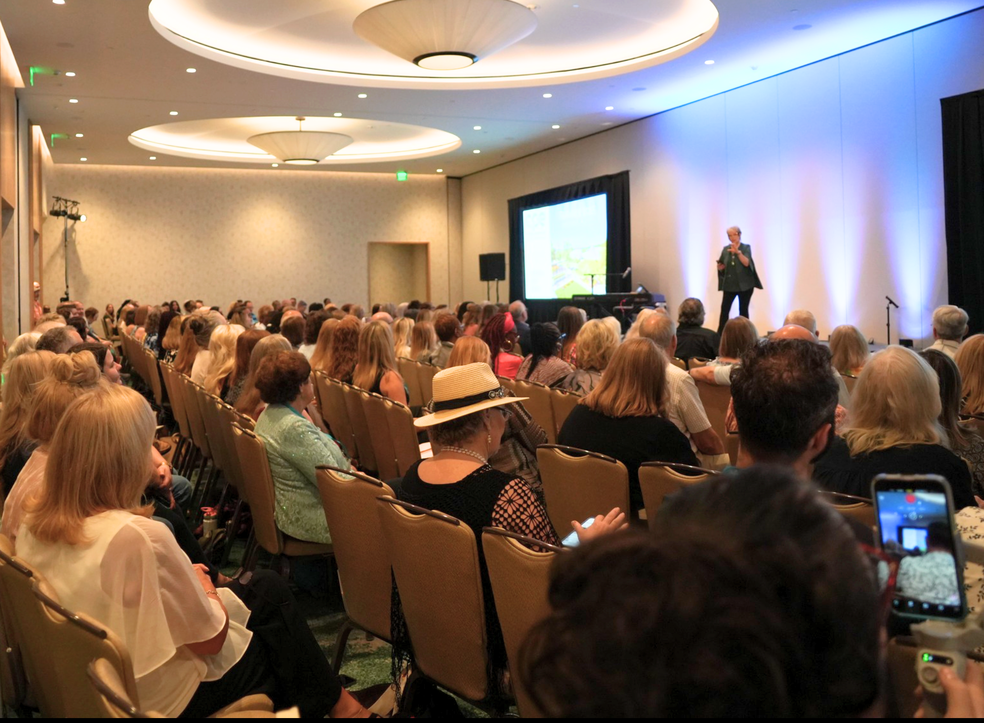 Conference plenary session with full audience and speaker on stage