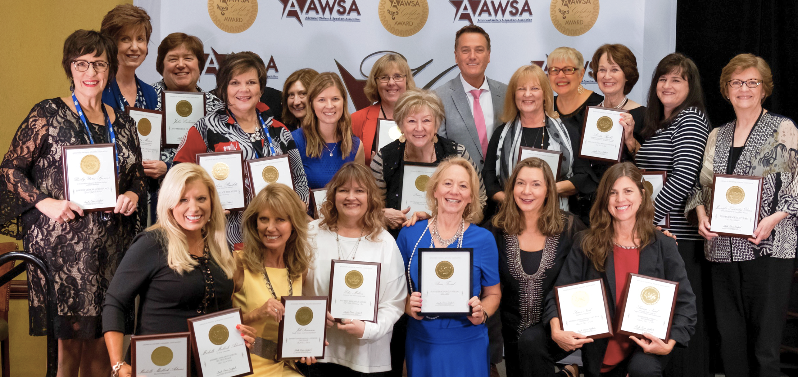 All 2024 Golden Scroll winners on stage with plaques in front of the AWSA backdrop