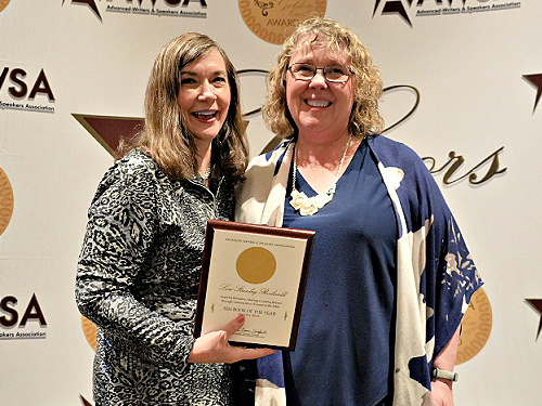 Lori Stanley Roeleveld receiving the 2024 Golden Scroll Book of the Year award